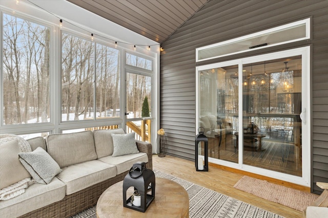 sunroom with wood ceiling, plenty of natural light, and lofted ceiling