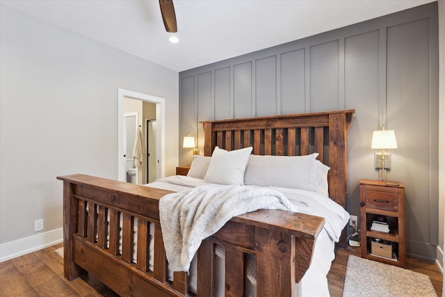 bedroom featuring ceiling fan, dark wood-type flooring, and ensuite bathroom