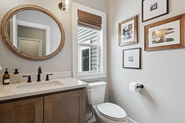 bathroom featuring toilet and vanity