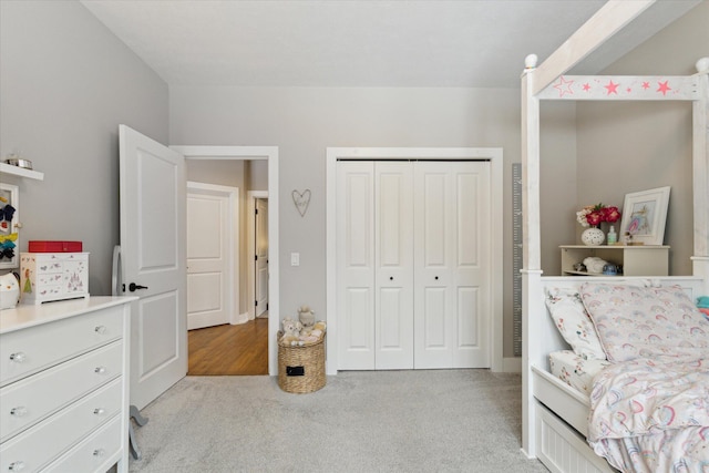 bedroom with light colored carpet and a closet