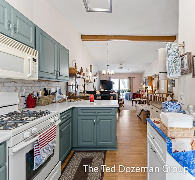 kitchen featuring pendant lighting, white appliances, vaulted ceiling with beams, backsplash, and kitchen peninsula