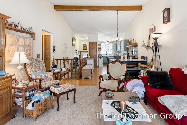 living room featuring beamed ceiling, high vaulted ceiling, light wood-type flooring, and a chandelier