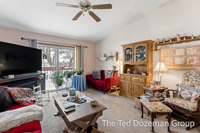 living room featuring ceiling fan, light colored carpet, and lofted ceiling