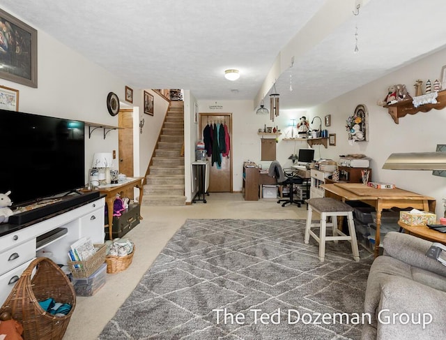 living room featuring carpet flooring and a textured ceiling