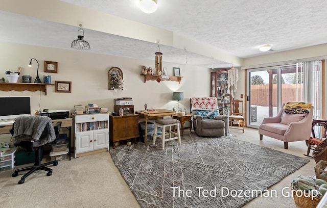 home office featuring carpet floors and a textured ceiling