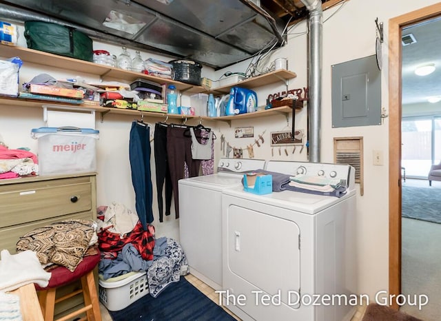 laundry area with washing machine and clothes dryer and electric panel