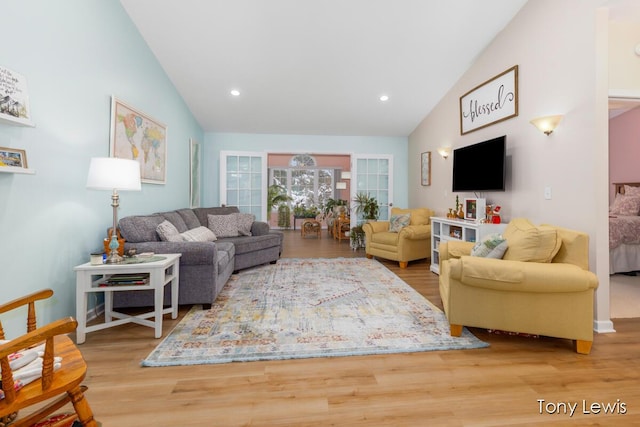 living room with lofted ceiling and hardwood / wood-style flooring