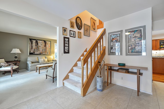 stairs featuring carpet flooring