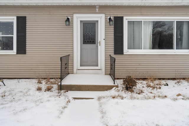 view of snow covered property entrance