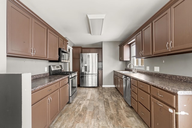 kitchen with stainless steel appliances, sink, and hardwood / wood-style floors