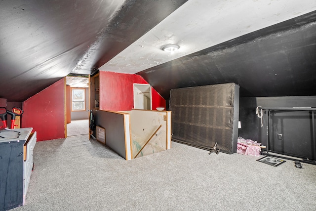 additional living space featuring lofted ceiling and light carpet