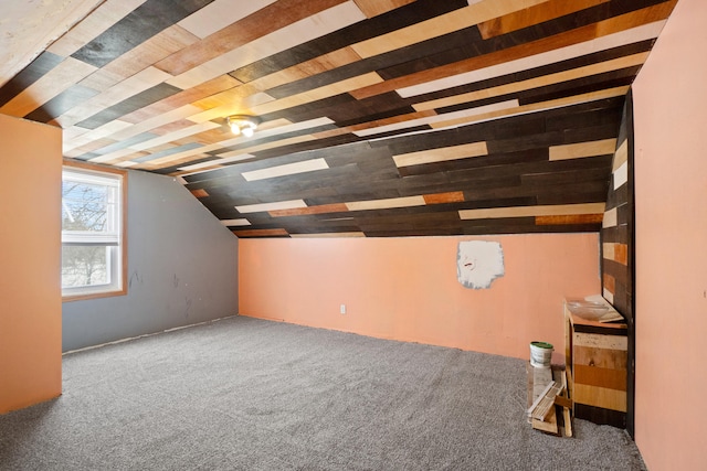 additional living space with vaulted ceiling and carpet