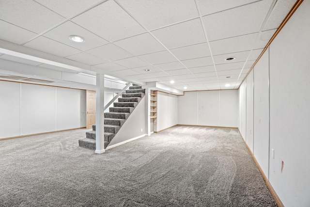 basement with carpet and a drop ceiling