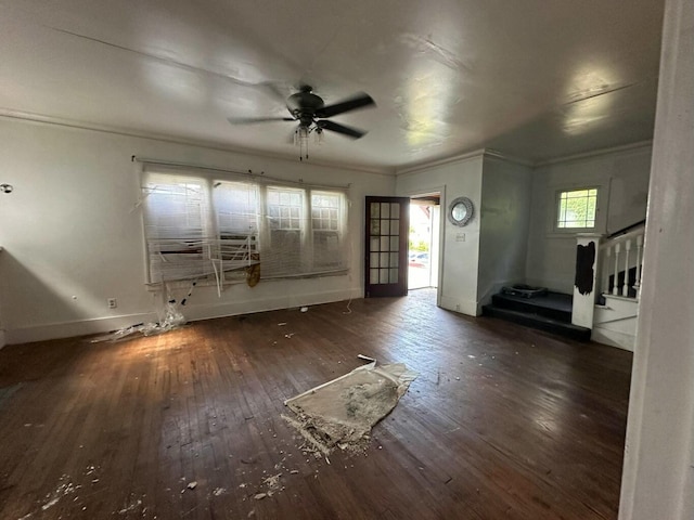 unfurnished living room featuring ceiling fan, crown molding, and dark hardwood / wood-style flooring