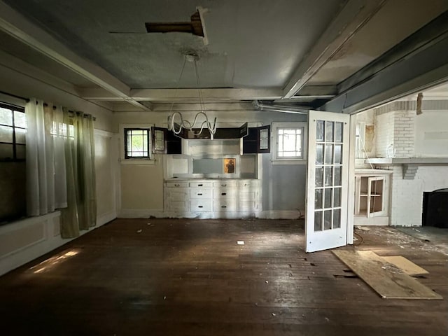 interior space featuring plenty of natural light, a fireplace, and dark hardwood / wood-style flooring