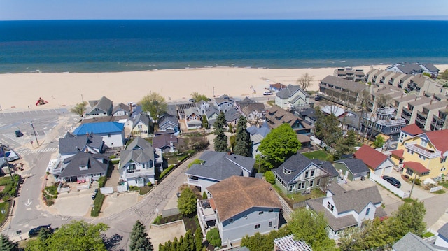 drone / aerial view with a water view and a view of the beach