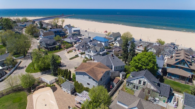 bird's eye view with a water view and a beach view