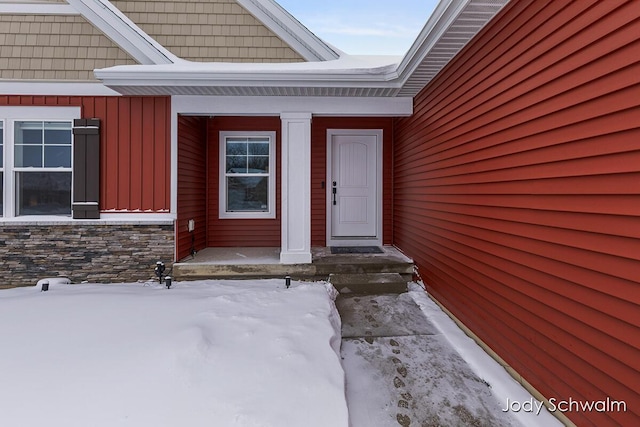 view of snow covered property entrance