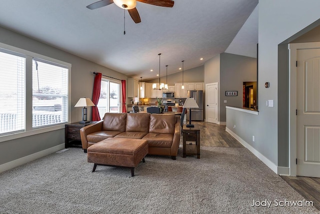 living room with dark hardwood / wood-style flooring, ceiling fan with notable chandelier, and vaulted ceiling