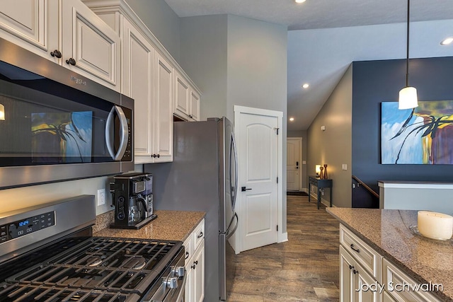 kitchen featuring white cabinetry, hanging light fixtures, dark wood-type flooring, and appliances with stainless steel finishes