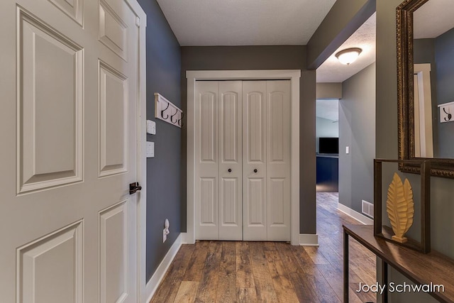 corridor with dark hardwood / wood-style floors