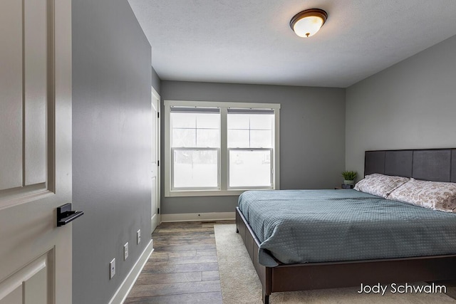 bedroom featuring hardwood / wood-style flooring and a textured ceiling