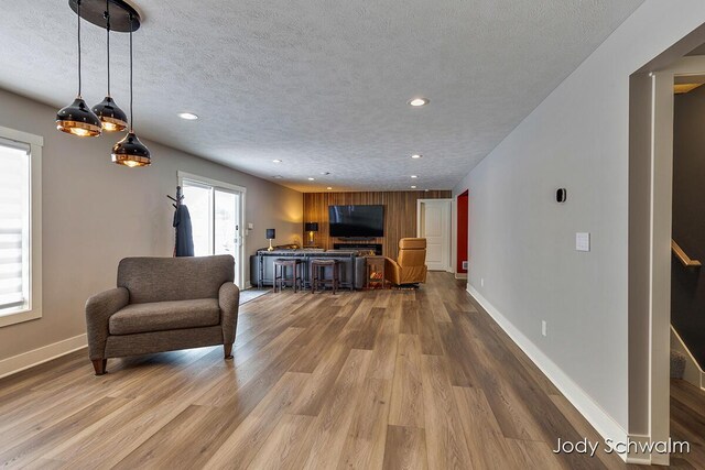 living room featuring light hardwood / wood-style floors and a textured ceiling