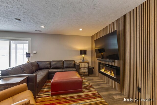 living room with dark hardwood / wood-style flooring and a textured ceiling