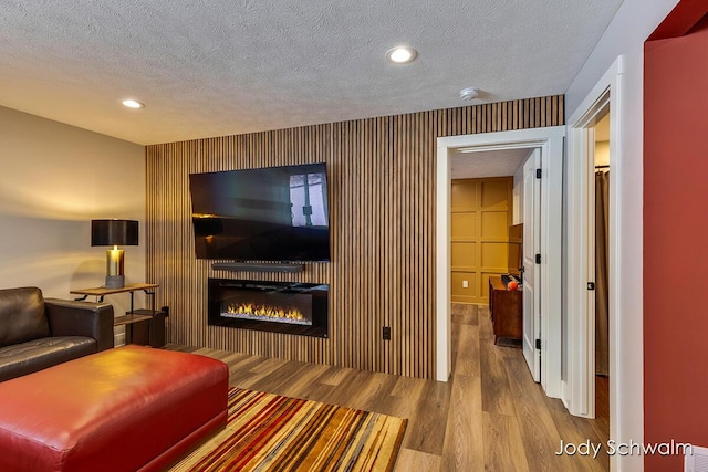 living room featuring light hardwood / wood-style flooring and a textured ceiling