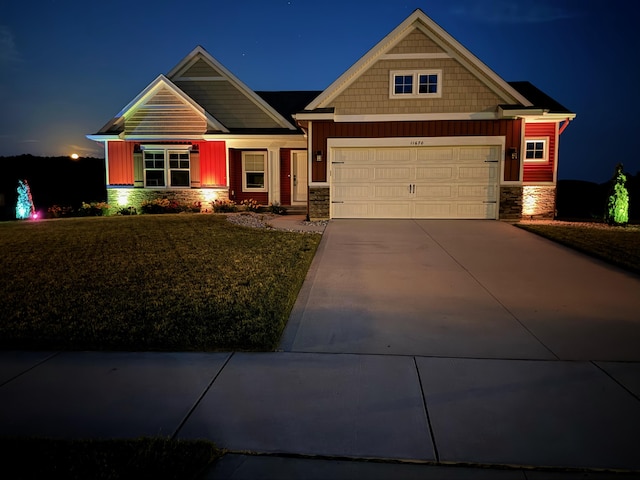 craftsman house with stone siding, an attached garage, and concrete driveway