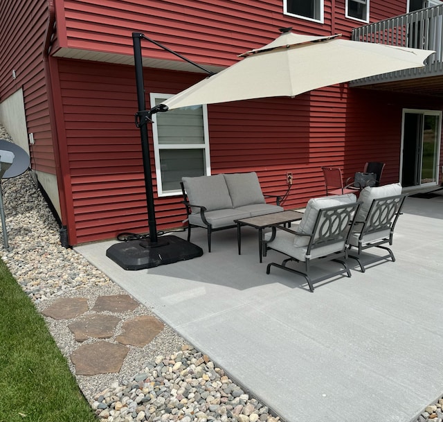 view of patio with an outdoor living space and a balcony