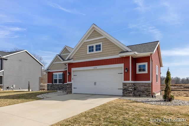 craftsman house featuring stone siding, an attached garage, driveway, and board and batten siding