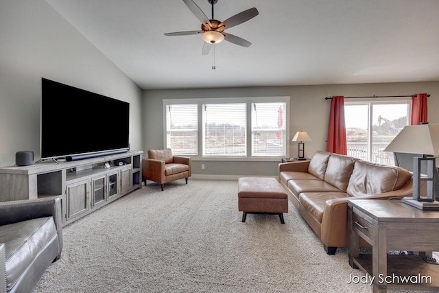 carpeted living room with vaulted ceiling and a ceiling fan