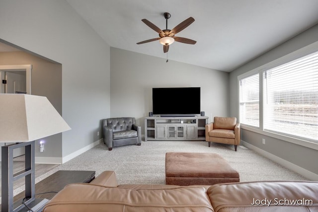 carpeted living area featuring baseboards, a ceiling fan, and vaulted ceiling