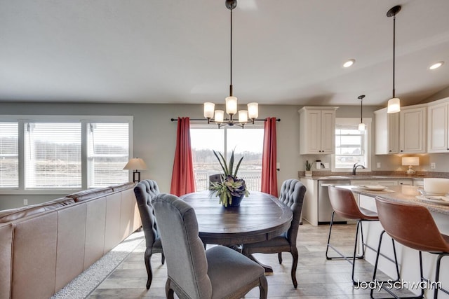 dining room featuring recessed lighting, light wood-type flooring, and a notable chandelier