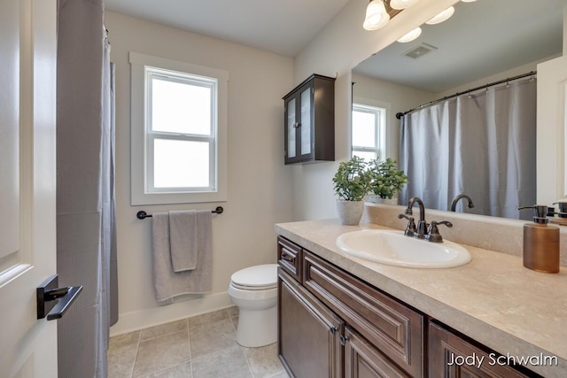 bathroom with vanity, toilet, visible vents, and tile patterned flooring