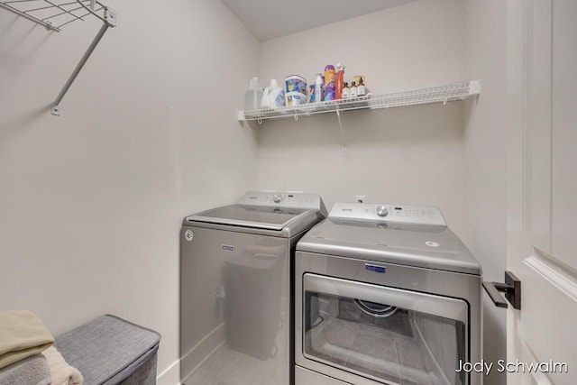 laundry room featuring washer and clothes dryer, laundry area, and baseboards