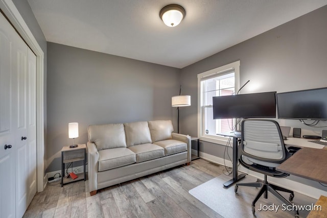 office featuring baseboards and wood finished floors