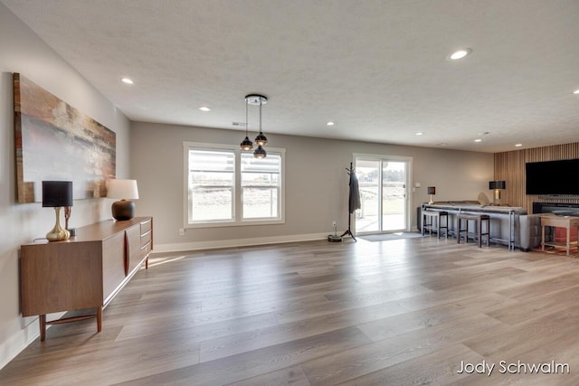 living area featuring recessed lighting, baseboards, and wood finished floors