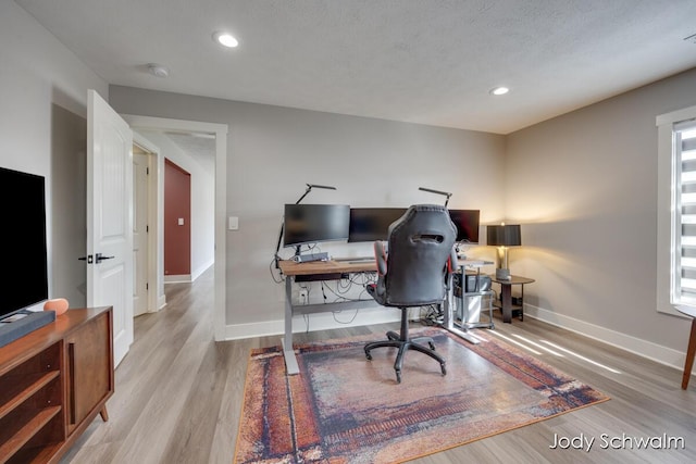 office space featuring recessed lighting, wood finished floors, baseboards, and a textured ceiling