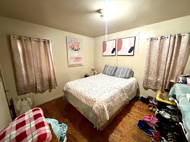 bedroom with dark hardwood / wood-style flooring