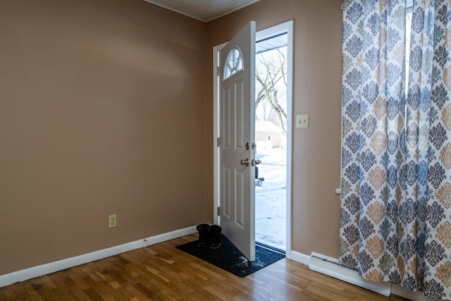 entrance foyer with baseboard heating and wood-type flooring