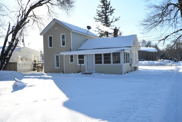 view of snow covered rear of property