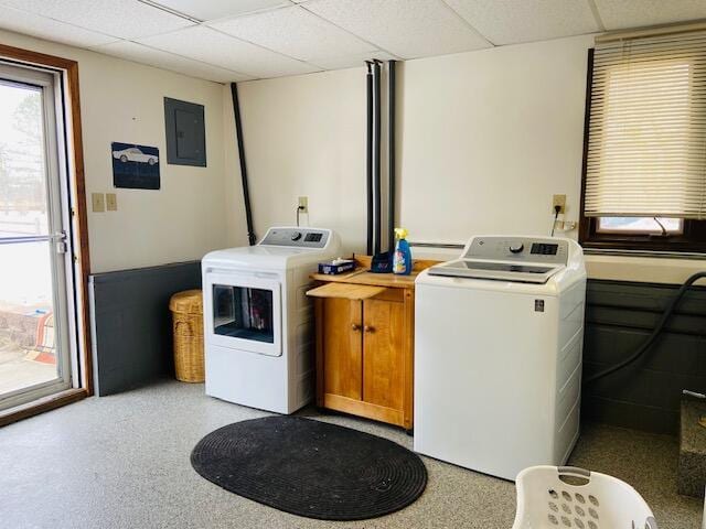 washroom featuring cabinets, washing machine and dryer, and electric panel