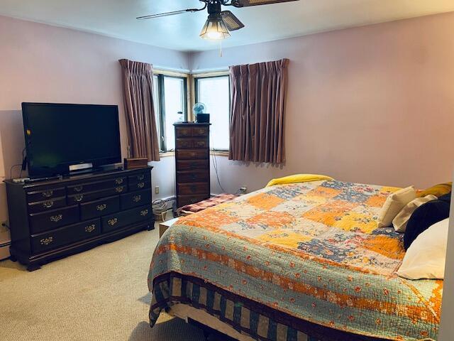 carpeted bedroom with ceiling fan