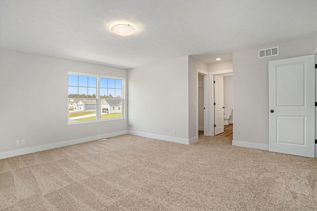 empty room featuring light colored carpet