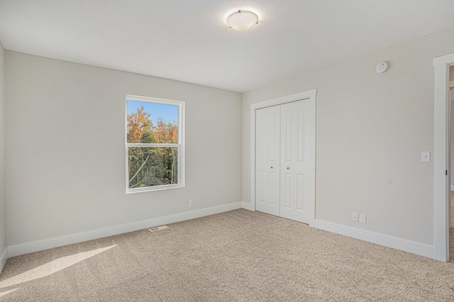 unfurnished bedroom featuring a closet and carpet flooring