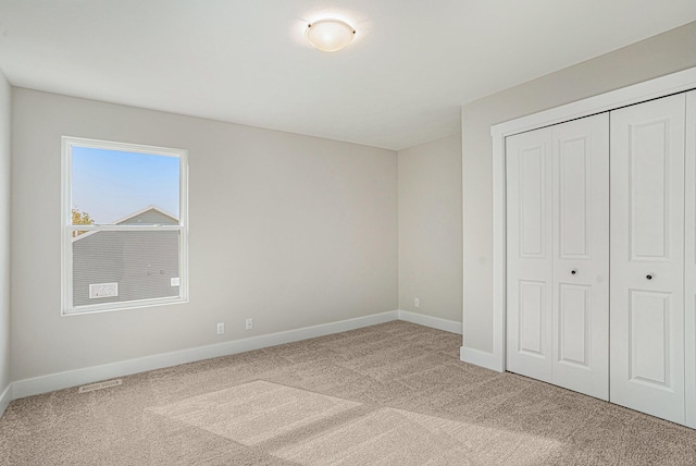 unfurnished bedroom with carpet floors and a closet