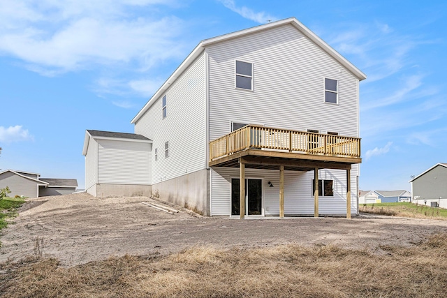 rear view of property featuring a wooden deck