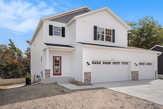 view of front of house featuring a garage and central air condition unit